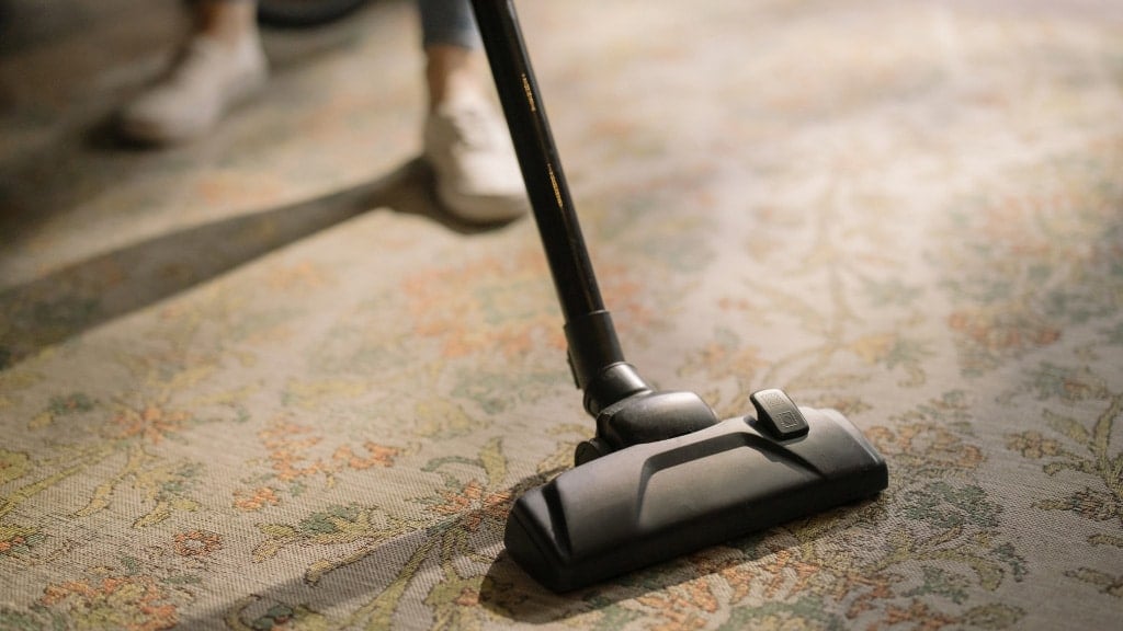 photo closup of a head of vacuum cleaner cleaning a rug