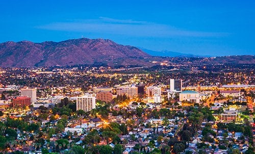 Riverside city skyline with urban buildings and water