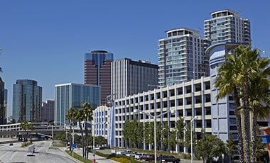 city view of orange county with palm trees and large office buildings