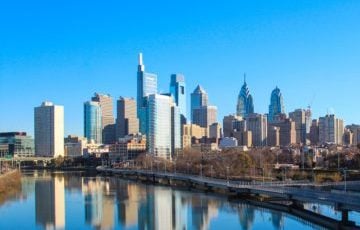 Philadelphia skyline with the Schuylkill River in foreground and skyline of modern buildings in the background