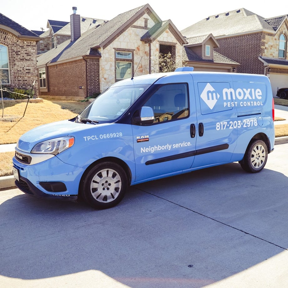 blue moxie pest control technician van sitting outside customer home