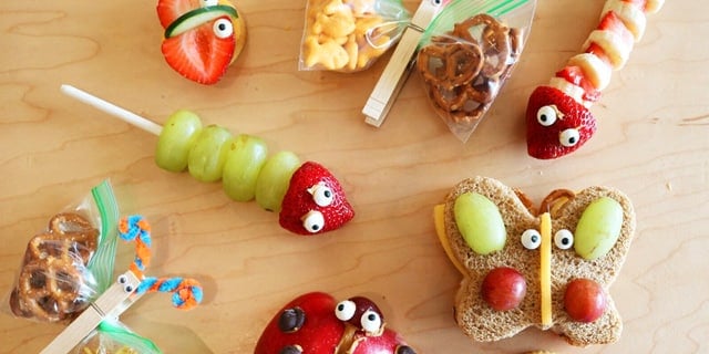 closeup of crafted food with googly eyes to look like different insect species