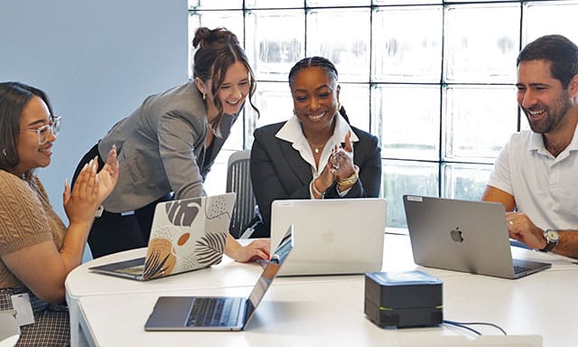 group of moxie pest control employees working together and laughing in conference room