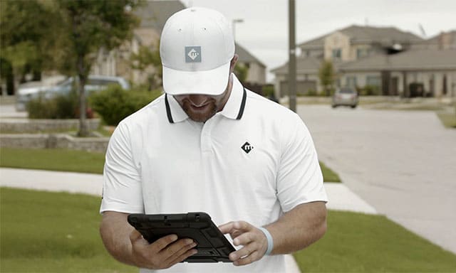 Moxie sales team member preparing quote for customer in neighborhood with ipad